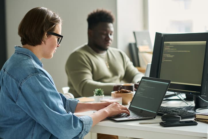 Image of development team members working at their desks - Developer productivity